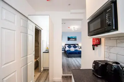 a room with a door leading to a bedroom at Five Seasons Liverpool City - Modern Studios near Anfield in Liverpool