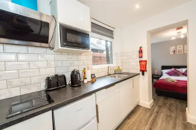 a kitchen with a sink and a microwave at Five Seasons Liverpool City - Modern Studios near Anfield in Liverpool