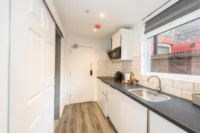 a kitchen with a sink and a window at Five Seasons Liverpool City - Modern Studios near Anfield in Liverpool