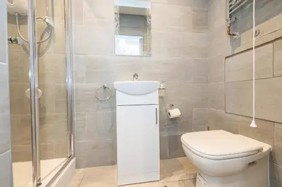 a bathroom with a toilet and a shower at Five Seasons Liverpool City - Modern Studios near Anfield in Liverpool