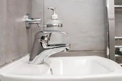 a bathroom sink with a chrome water faucet at Five Seasons Liverpool City - Modern Studios near Anfield in Liverpool
