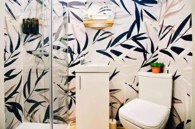 a bathroom with a toilet and floral wallpaper at XxHot TubxX 4Bed semi, sleeps 8, 2 bathrooms in Blackpool