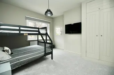 a bedroom with a bunk bed and a flat screen tv at XxHot TubxX 4Bed semi, sleeps 8, 2 bathrooms in Blackpool