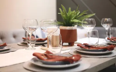a table with plates of hot dogs and wine glasses at XxHot TubxX 4Bed semi, sleeps 8, 2 bathrooms in Blackpool
