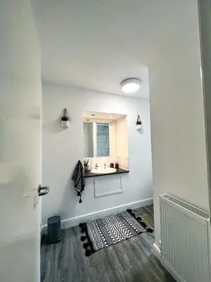 a bathroom with a sink and a mirror on the wall at The County Staycation in Liverpool