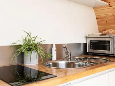 a kitchen with a sink and a microwave at Low Longlands in Cartmel