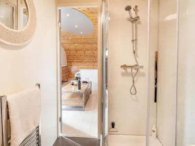 a shower with a glass door in a bathroom at Middle Longlands in Cartmel