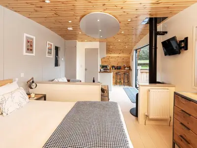 a bedroom with a bed and a kitchen in a room at Middle Longlands in Cartmel