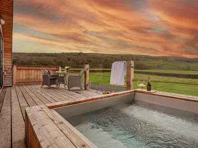 a hot tub on the deck of a house at Middle Longlands in Cartmel