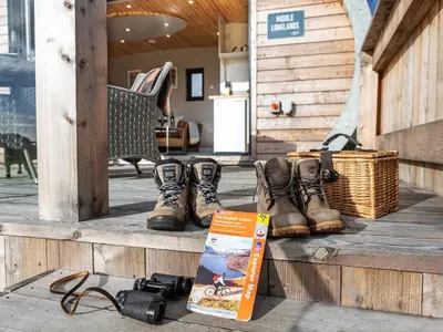 a book and boots on a wooden porch at Middle Longlands in Cartmel