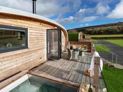 a house with a deck and a swimming pool at Middle Longlands in Cartmel