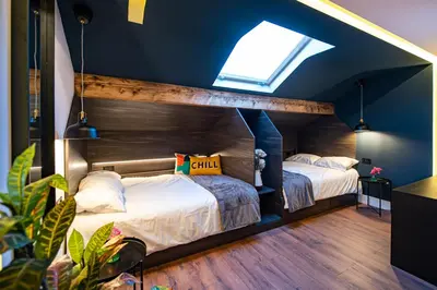 two beds in a room with a blue ceiling at The Nest - Luxury 16 person Apt w jacuzzi & parking in Blackpool