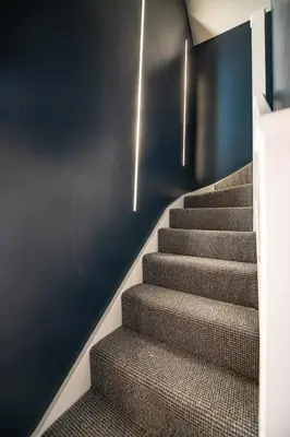 a staircase with a carpeted stair case with lights at The Nest - Luxury 16 person Apt w jacuzzi & parking in Blackpool