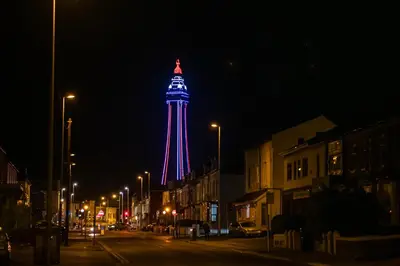 a tower lit up in red and blue at night at The Nest - Luxury 16 person Apt w jacuzzi & parking in Blackpool