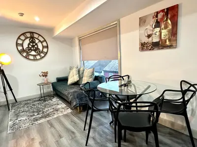 a living room with a couch and a table at York Street Apartments by Blackpool Service Apartments in Blackpool