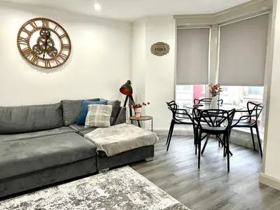 a living room with a couch and a table at York Street Apartments by Blackpool Service Apartments in Blackpool