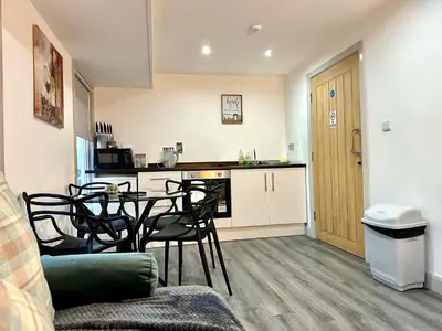 a kitchen with a table and chairs in a room at York Street Apartments by Blackpool Service Apartments in Blackpool