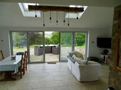 a living room with a white couch and a table at Swans Farm in Lancaster