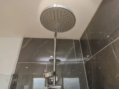 a shower head hanging from a ceiling in a bathroom at Harbour Retreat in Millom