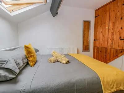 a bedroom with a large bed with two pillows on it at Harbour Retreat in Millom