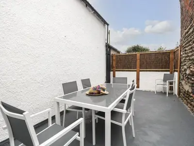a white table and chairs on a patio at Harbour Retreat in Millom