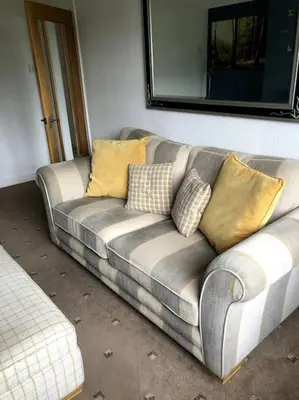 a couch with pillows on it in a room at 2 Bedroom Bungalow in Mawdesley