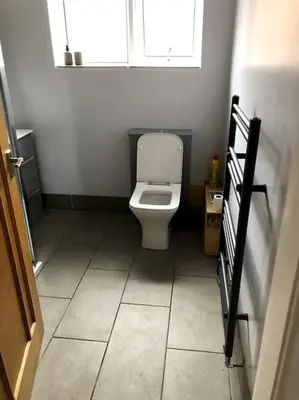 a bathroom with a toilet and a window at 2 Bedroom Bungalow in Mawdesley