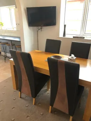 a conference room with a wooden table and chairs at 2 Bedroom Bungalow in Mawdesley