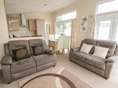 a living room with two chairs and a couch at Waterside Lodge in Carnforth