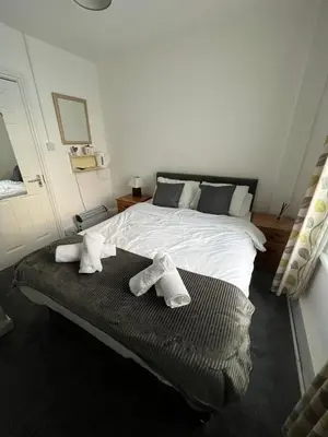 a bedroom with a bed with two towels on it at The Wilton Hotel in Blackpool