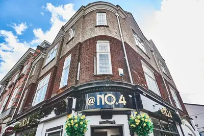a large brick building with a noa sign on it at The Little Bear Apartment Birkdale Village in Southport