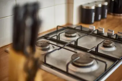 a stove top with a bunch of burners on it at The Little Bear Apartment Birkdale Village in Southport