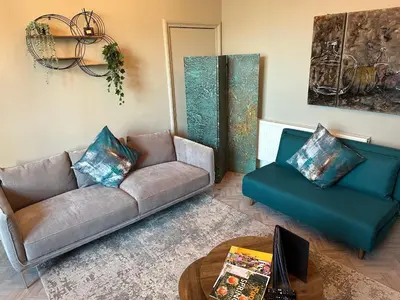 a living room with a couch and a table at Ashton Mews apartment with free parking in Saint Annes on the Sea