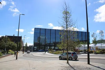 a car parked in a parking lot in front of a building at Two Bedroom Apartment, Free parking, Close to UCLAN and free WIFI in Preston