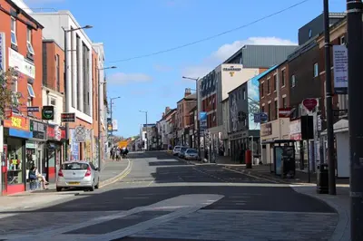 an empty city street with a car parked on the street at Two Bedroom Apartment, Free parking, Close to UCLAN and free WIFI in Preston