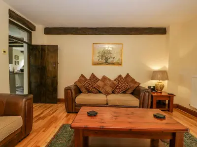 a living room with a couch and a table at Ewedale Farm in Ulverston