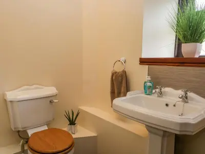 a bathroom with a sink and a toilet at Ewedale Farm in Ulverston