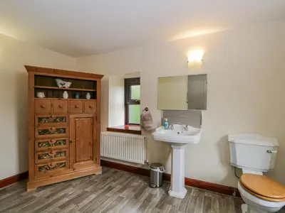 a bathroom with a toilet and a sink at Ewedale Farm in Ulverston