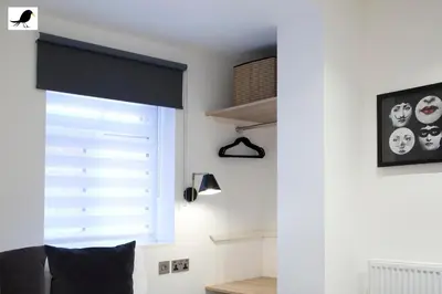 a window with a black roller blind in a room at Blackbird Accommodation and Luxury Apartments room 12 in Blackpool