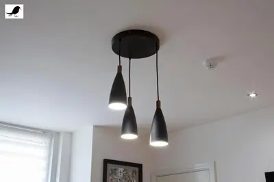 a room with three lights hanging from the ceiling at Blackbird Accommodation and Luxury Apartments room 12 in Blackpool