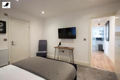 a bedroom with a bed and a flat screen tv at Blackbird Accommodation and Luxury Apartments room 12 in Blackpool
