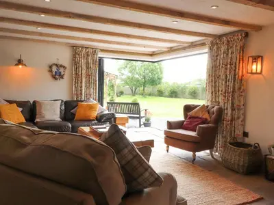 a living room with couches and a large window at Old Bell Works in Preston