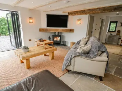 a living room with a couch and a fireplace at Old Bell Works in Preston