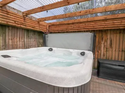 a large bath tub in a wooden building at Old Bell Works in Preston