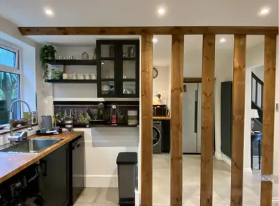 a kitchen with wooden walls and a counter top at Luxury Oriental Home with Exotic Garden & Free Parking in West Derby