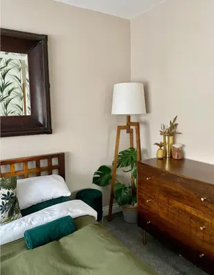 a bedroom with two beds and a dresser and a lamp at Luxury Oriental Home with Exotic Garden & Free Parking in West Derby