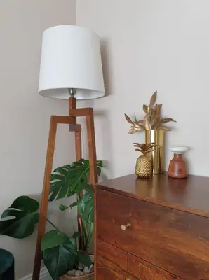 a lamp sitting on top of a dresser with plants at Luxury Oriental Home with Exotic Garden & Free Parking in West Derby