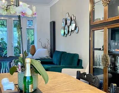 a living room with a table and a couch at Luxury Oriental Home with Exotic Garden & Free Parking in West Derby