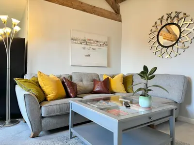 a living room with a couch and a table at Warehouse Apartment-1 King Bed Sleeps 2 in Ulverston