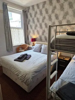 a bedroom with two bunk beds and a window at Stafford House in Blackpool